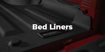 A WeatherTech bed liner installed in a red truck.