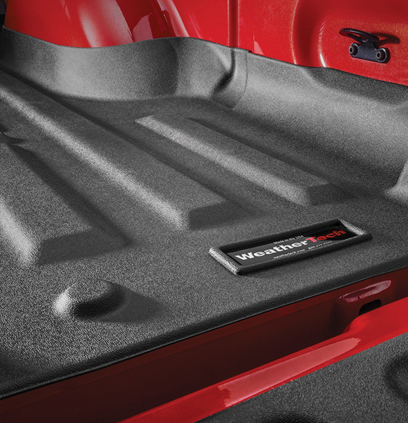 A truck bed, with a spray in bedliner installed from the WeatherTech brand.