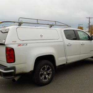 Photo of a white SnugPro on top of a chevrolet truck.