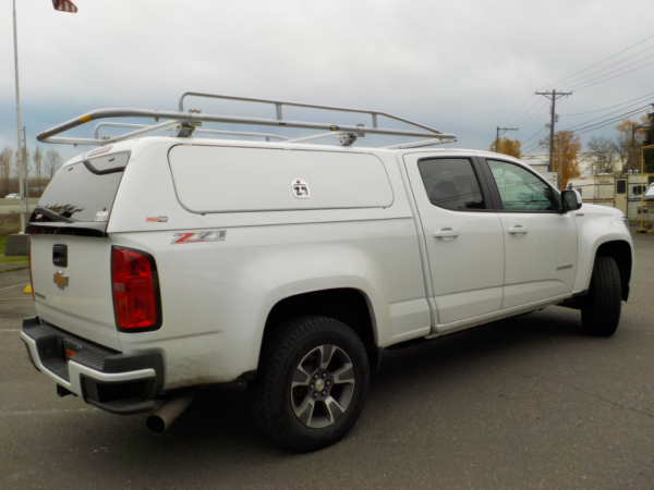 Photo of a white SnugPro on top of a chevrolet truck.