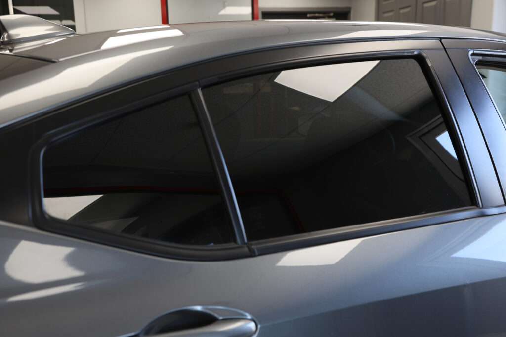 window tint after - Nobile Brothers Truck Accessory Centers A gray car in a garage, after receiving a window tint.
