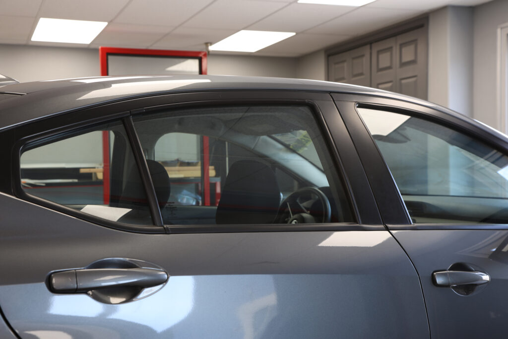 window tint before - Nobile Brothers Truck Accessory Centers A gray car in a garage, before receiving a window tint.