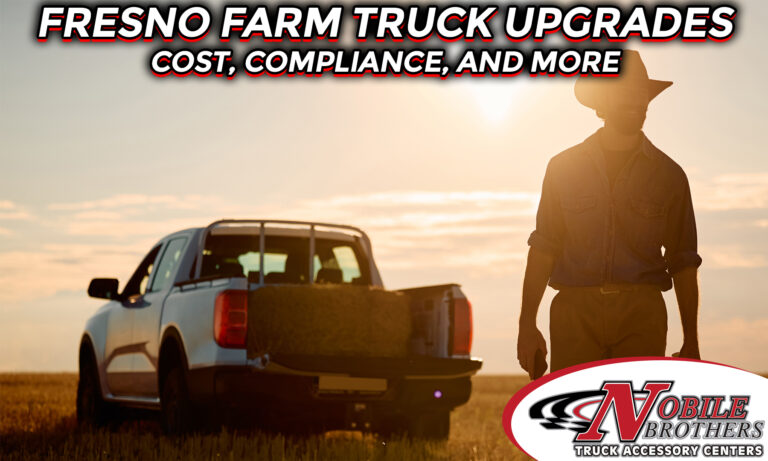 A man stands in a field with a farm truck in the background.