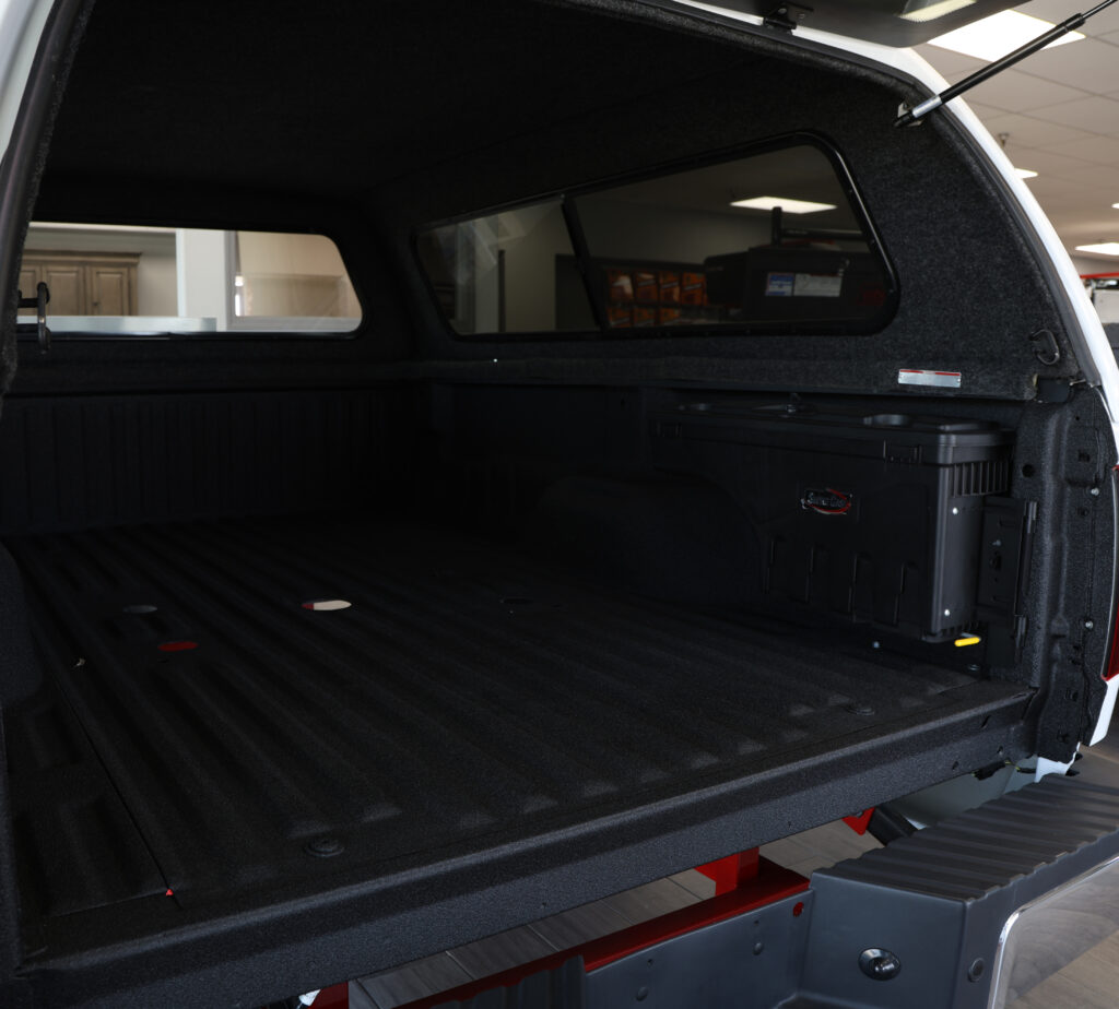 A truck bed with a spray on bed liner, within the Fresno store location.